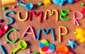 The words summer camp made out of playdough with beach toys scattered around it.